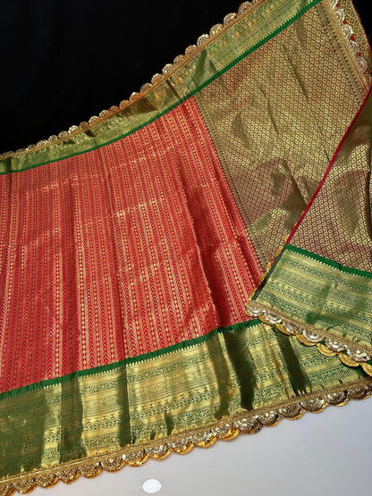 Red with green kanchivaram semi pattu saree with intricate aari lace border